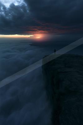 A blue hour sky scene of sunrise, clouds, fog.