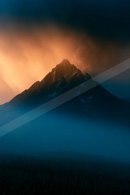 A blue hour high contrast landscape of a volcano, fog.