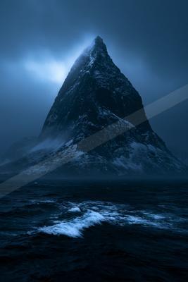 A black-toned moody photograph of promontory, cliff, volcano.