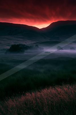 A dramatic sky scene of sunrise, valley, field.