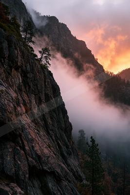 A serene landscape of mountains, sunrise, valley.