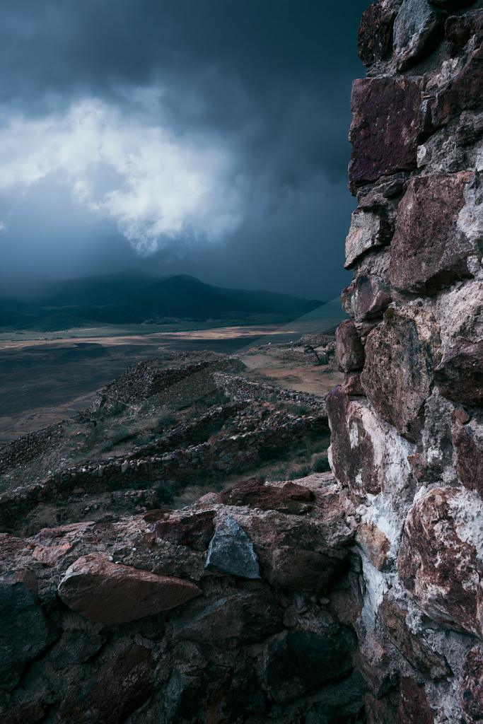 A dramatic sky scene of storm, mountains, clouds.