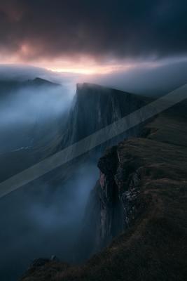 A dramatic long exposure landscape of mountains, valley, sunrise.