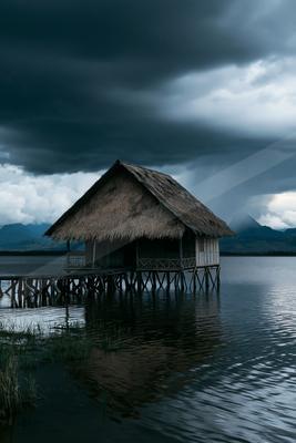 A moody water scene of lake, storm.