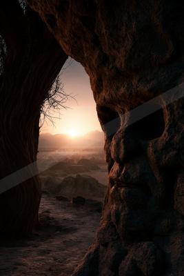 A golden hour landscape of valley, sunrise, rocks.