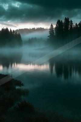 A blue hour long exposure water scene of lake, fog.