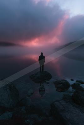 A mysterious double exposure sky scene of a sunrise, reflection.