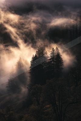 A brown-toned moody photograph of alp, valley, castle.