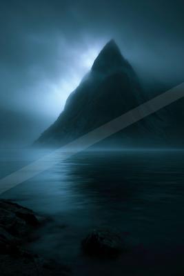 A towering mountain peak emerges from misty darkness, reflected in tranquil waters below.