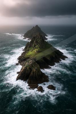 A dramatic water scene of ocean, storm, mountains.