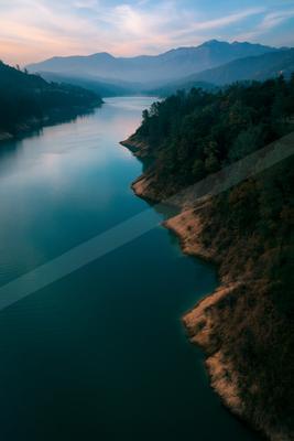A moody water scene of lake, valley, river.