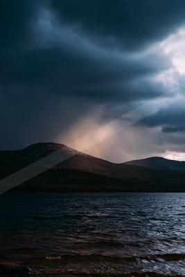 A night high contrast sky scene of a storm, ripples.