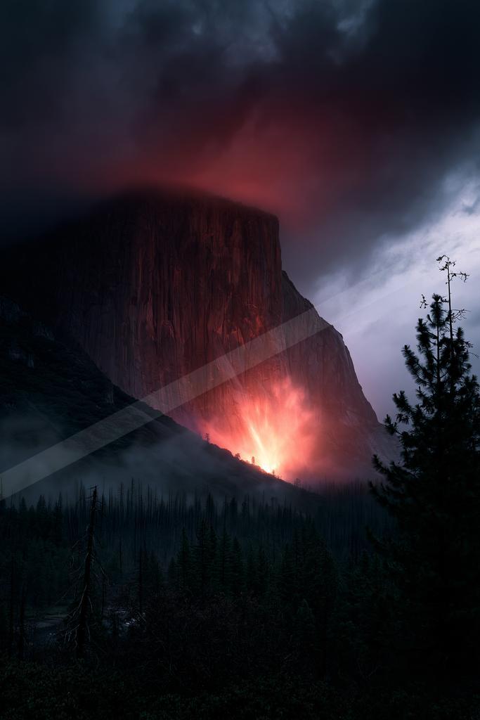 A moody landscape of mountains, valley.
