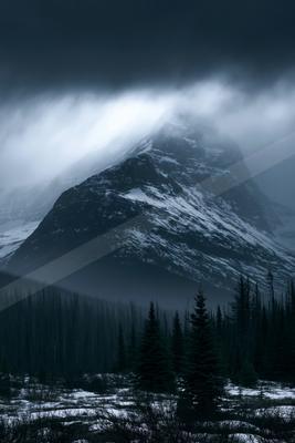 A moody landscape of mountains.
