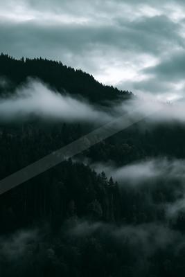 A brown-toned moody photograph of alp, valley, lakeside.
