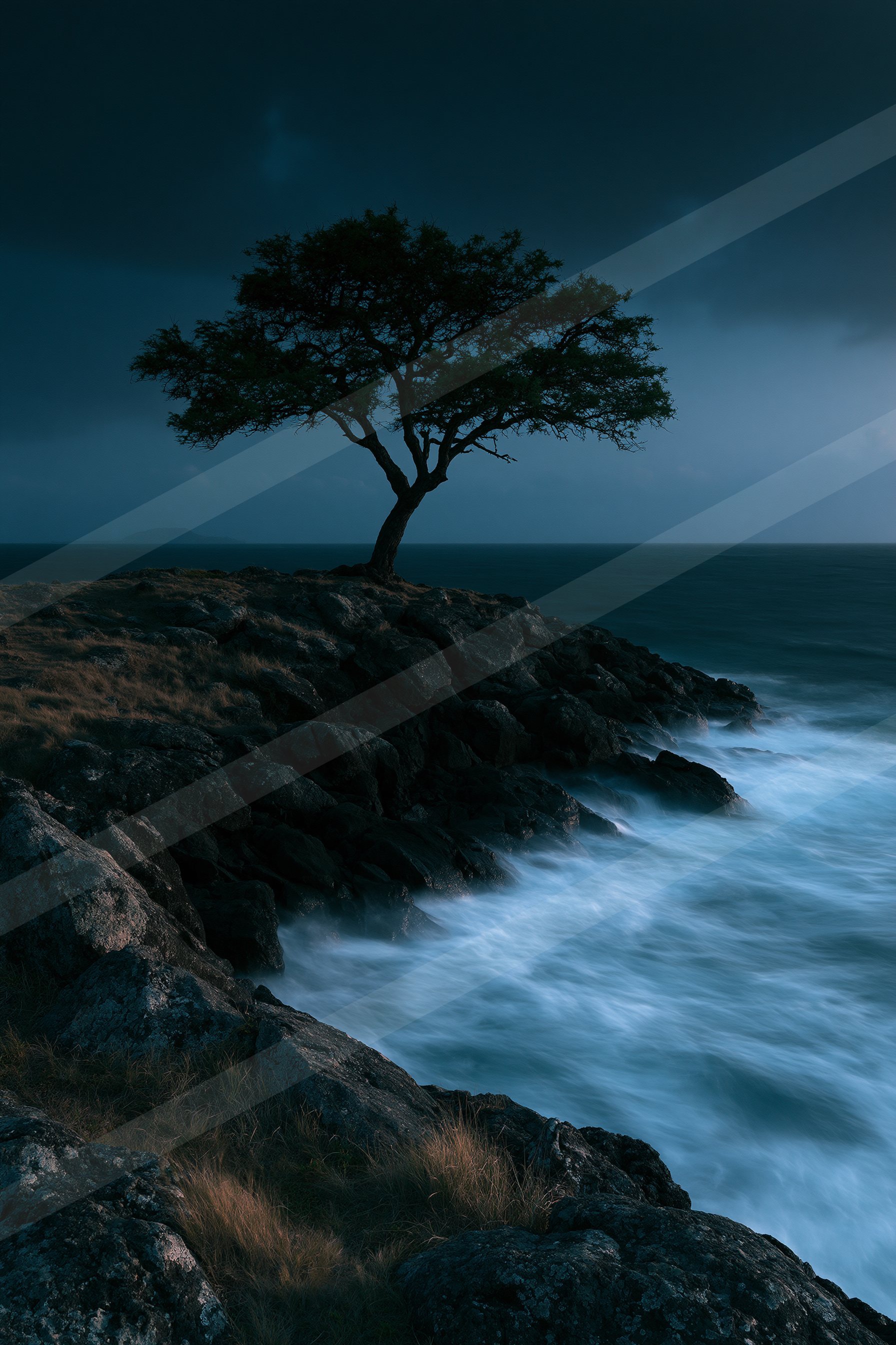 A blue hour long exposure water scene of a coastline.