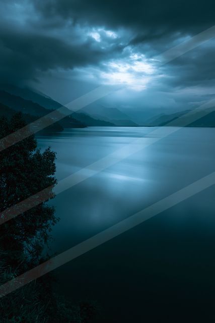 A blue hour long exposure water scene of a lake, fog.