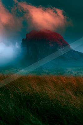 A moody landscape of mountains, field, still life.