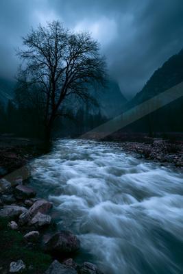 A dramatic long exposure water scene of a river, fog.