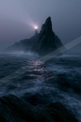 A lighthouse with a bright beam stands atop a jagged rocky island surrounded by turbulent dark ocean waves under a foggy night sky.