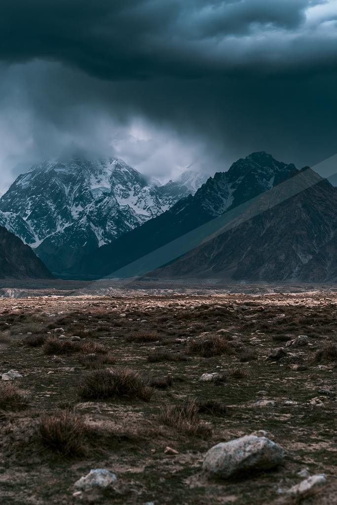 A brown-toned moody photograph of mountain tent, valley, alp.