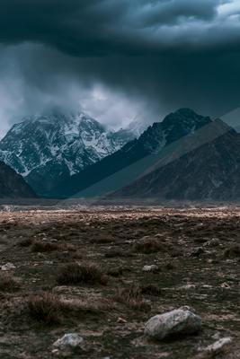 A brown-toned moody photograph of mountain tent, valley, alp.
