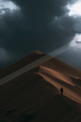 A night long exposure landscape of desert, storm, silhouette.