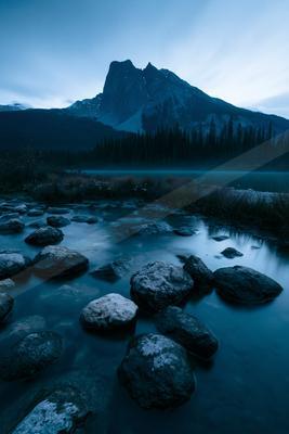 A blue hour long exposure landscape of mountains, river, valley.