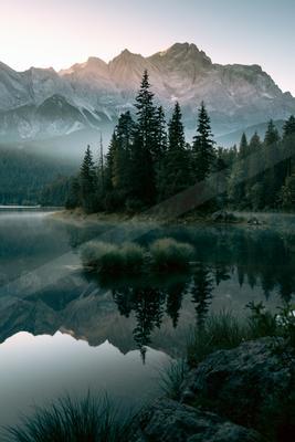 A serene landscape of mountains, lake.