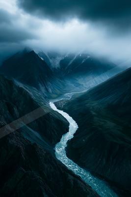 A dramatic long exposure water scene of river, mountains, valley.