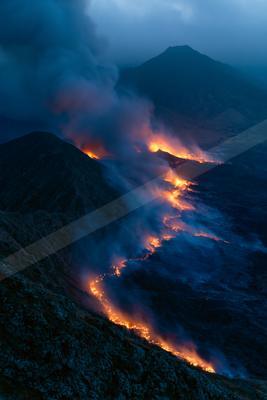 A moody landscape of a volcano, fire.