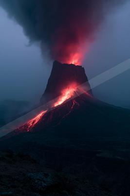 A powerful volcanic eruption at night, with bright red molten lava flowing down the mountain slopes and a massive plume of dark smoke illuminated in red rising 