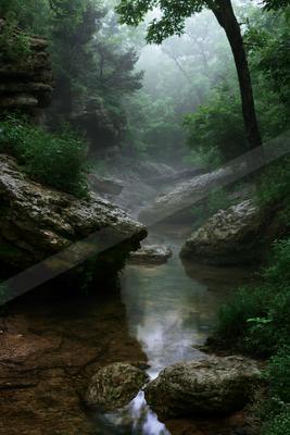 A serene water scene of river, waterfall, valley.