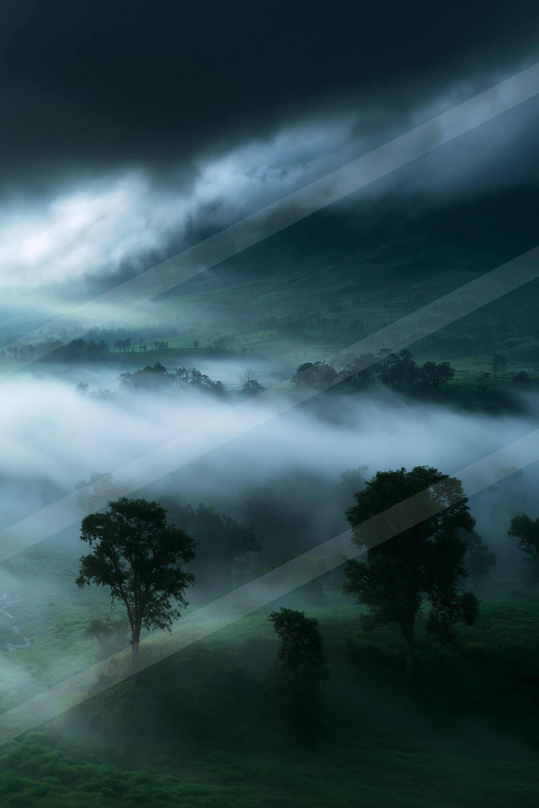 A dramatic high contrast landscape of a rolling hills, fog.