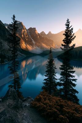 A serene landscape of mountains, lake, valley.
