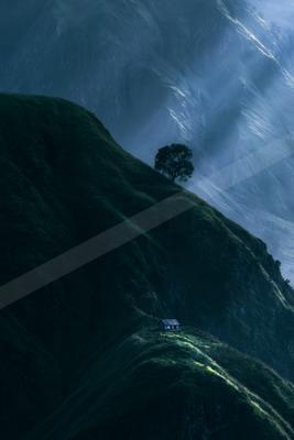 A moody landscape of mountains, valley, field.