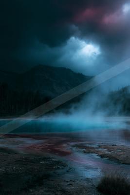 A blue hour water scene of lake, mountains, valley.