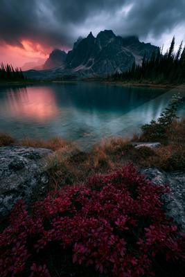 A serene landscape of mountains, lake, valley.