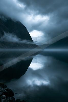 A night long exposure water scene of lake, fog.