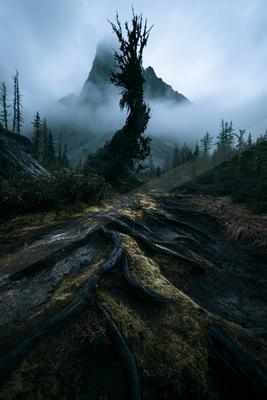 An ethereal high contrast landscape of a volcano, fog.