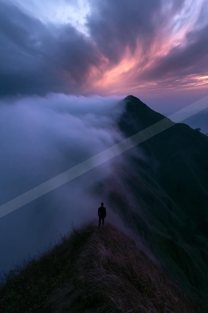 A blue hour long exposure landscape of mountains, sunrise, clouds.