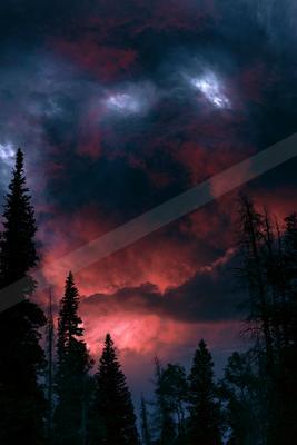 A night sky scene of clouds, sunrise, storm.