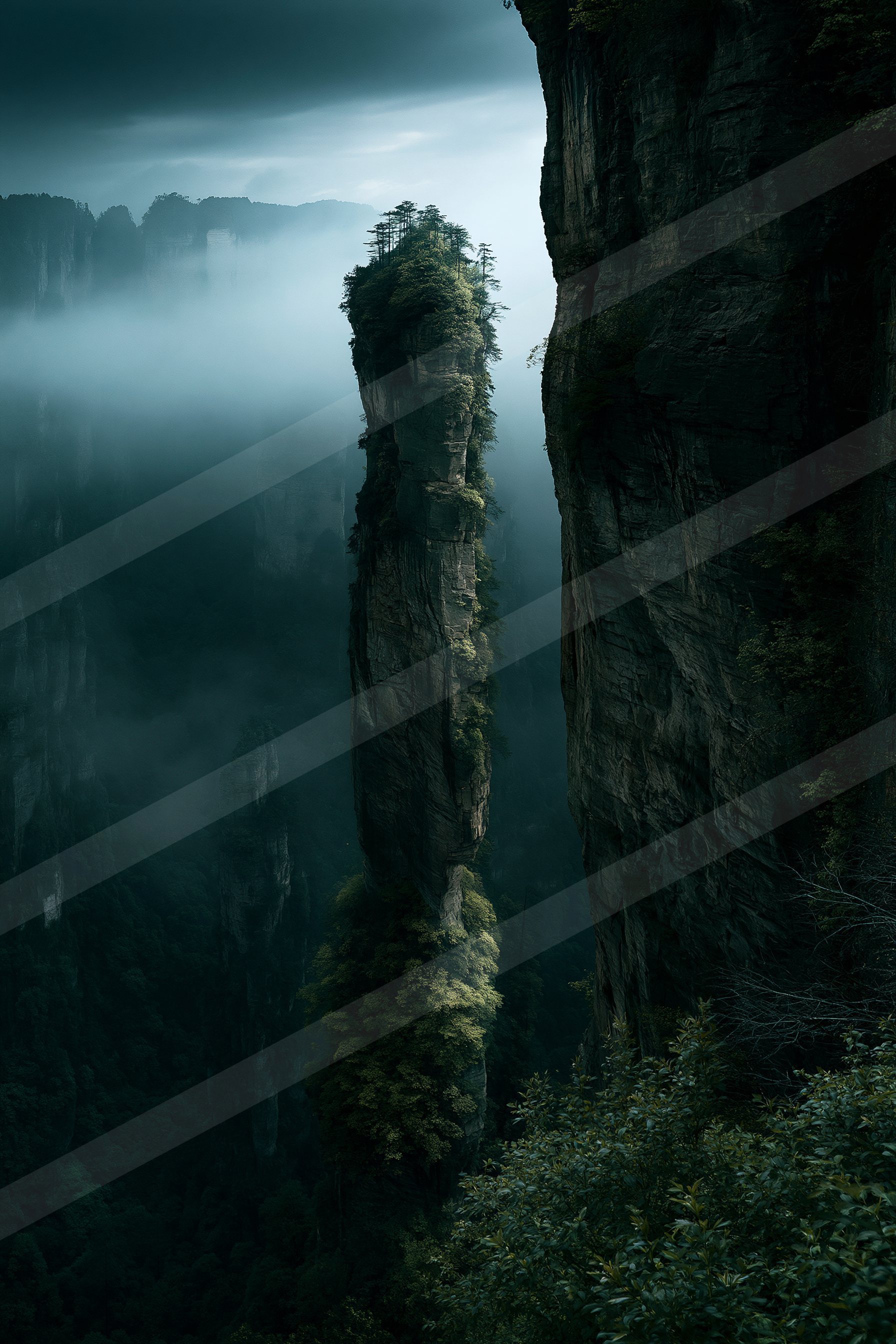 A serene mountain landscape shrouded in mist, showcasing towering vertical rock formations covered in lush greenery.