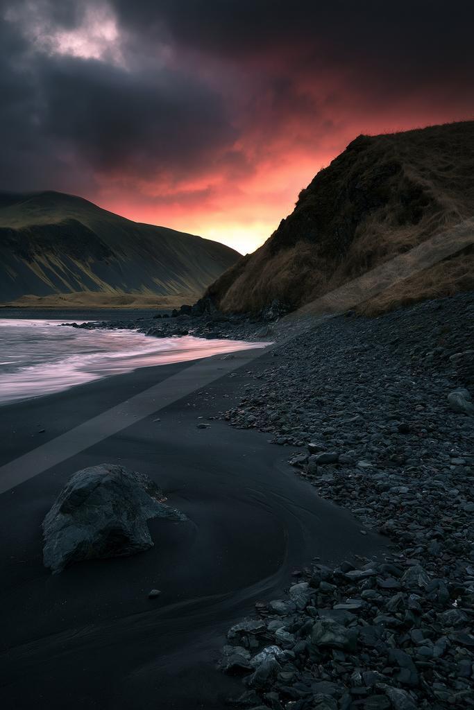 A moody water scene of beach, desert, valley.