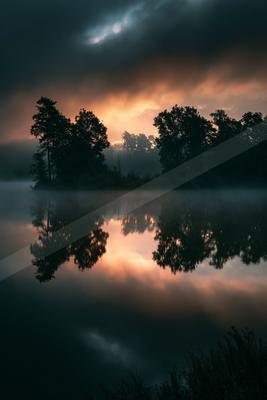 A black-toned moody photograph of lakeside, boathouse, canoe.