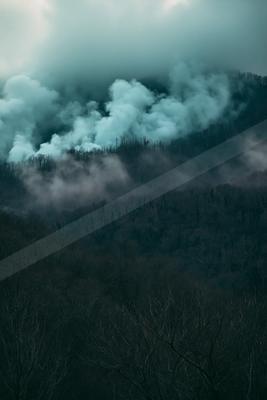 A green-toned moody photograph of volcano, geyser, alp.