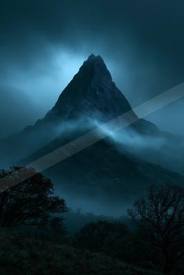 A sharp rocky mountain peak rises dramatically through thick blue mist and clouds at night, with silhouetted trees in the foreground.