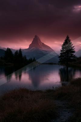 A dramatic water scene of lake, mountains.