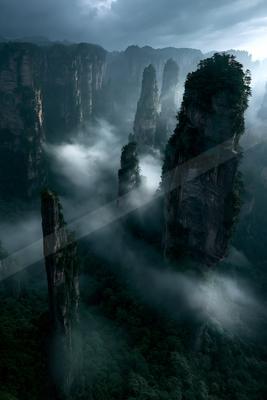 A dramatic landscape of a canyon, fog.