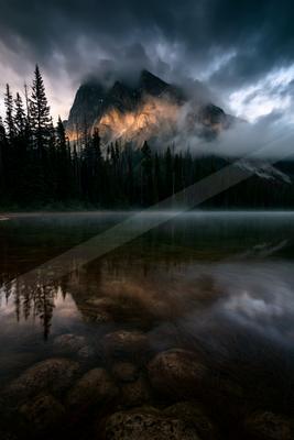 A serene landscape of mountains, lake.